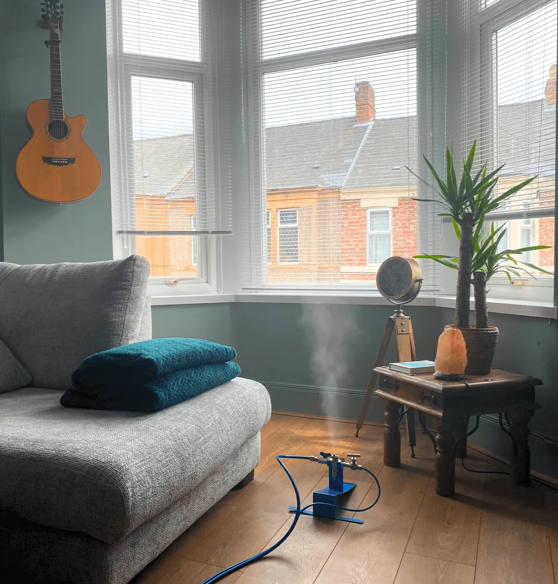 Dry fog disinfection device releasing mist in a furnished living room